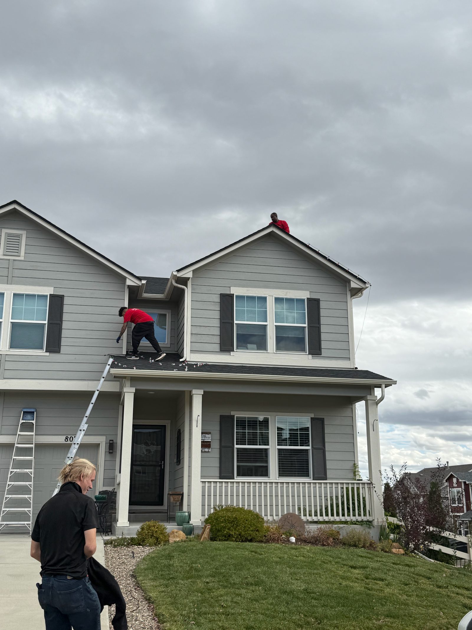 Our Front Range crew installing warm white C9 Christmas lights on a two-story home roofline Our Front Range crew installing warm white C9 Christmas lights on a two-story home roofline