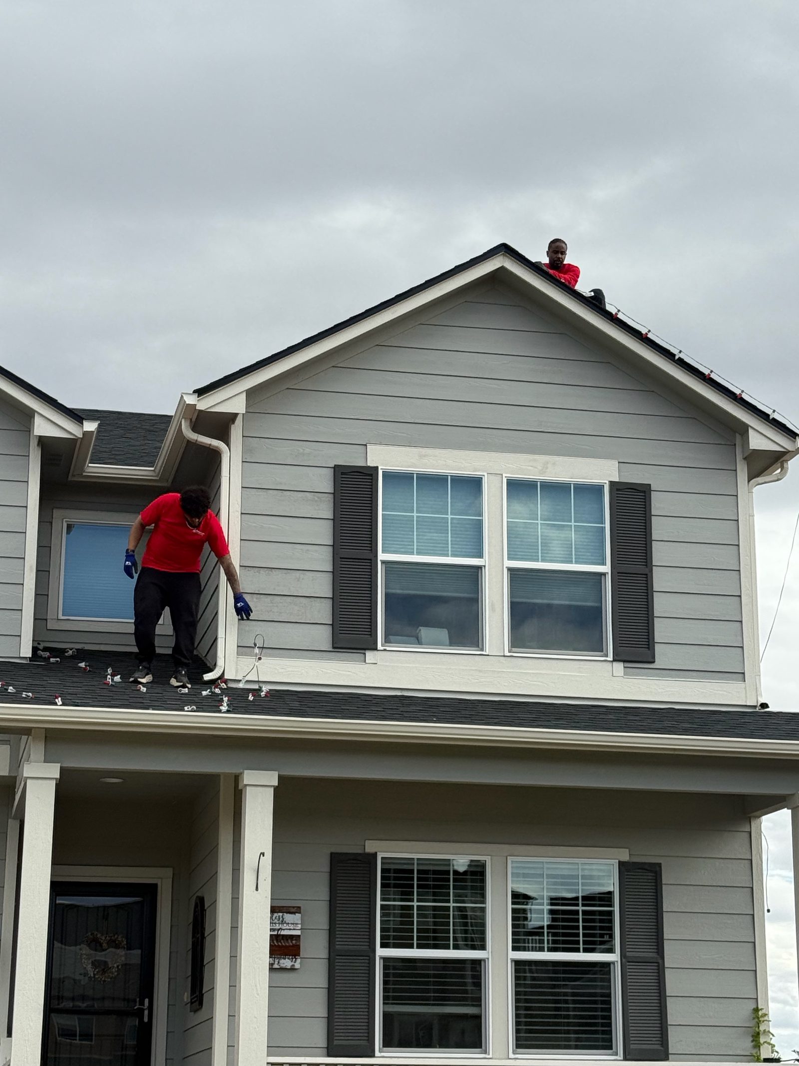 Professional Christmas light installation crew on roof installing LED lights, Front Range portfolio Professional Christmas light installation crew on roof installing LED lights, Front Range portfolio